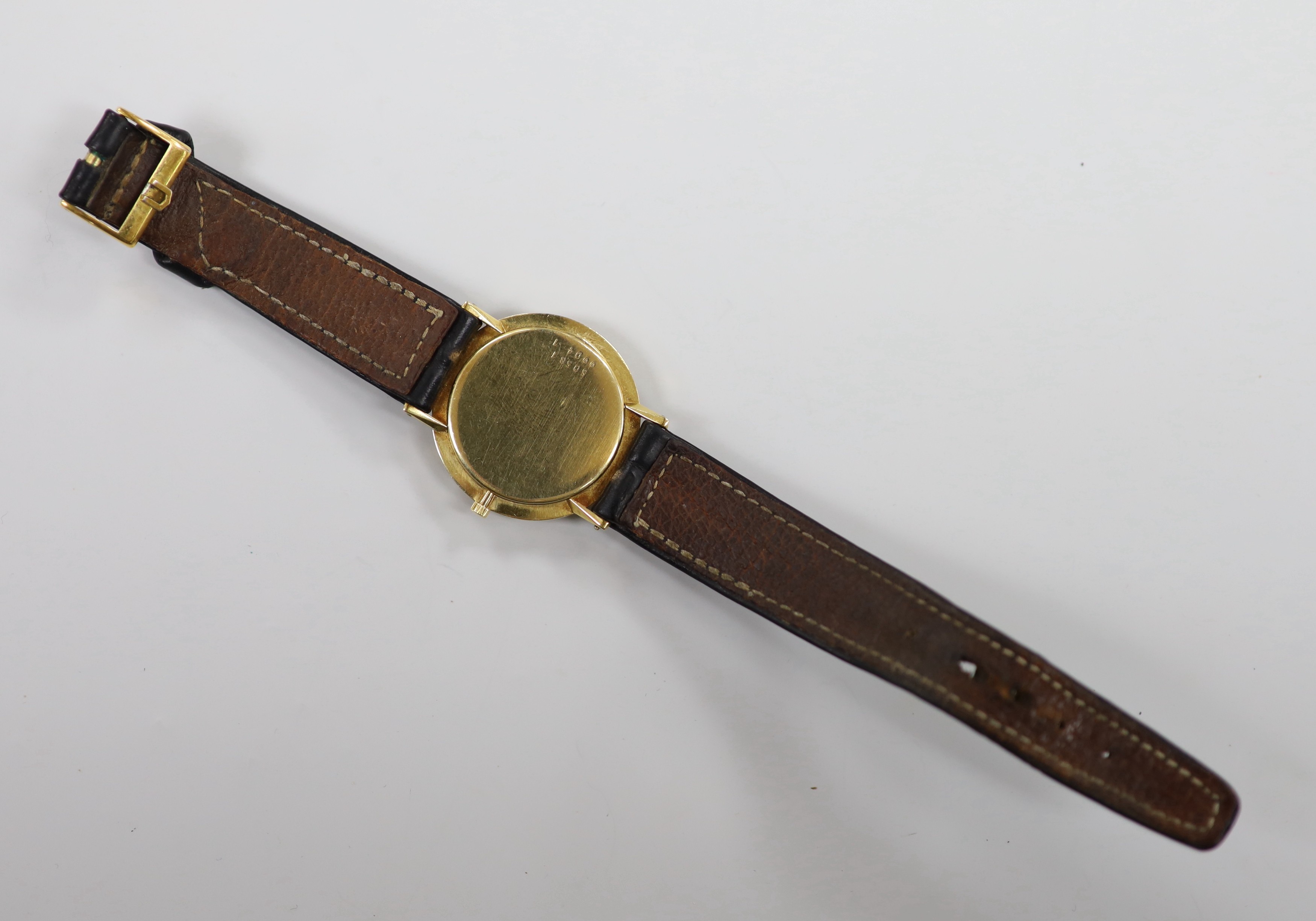 A gentleman's 18ct gold Universal manual wind wrist watch, with baton numerals, on a leather strap with gold plated Universal buckle, gross weight 28.1 grams.
